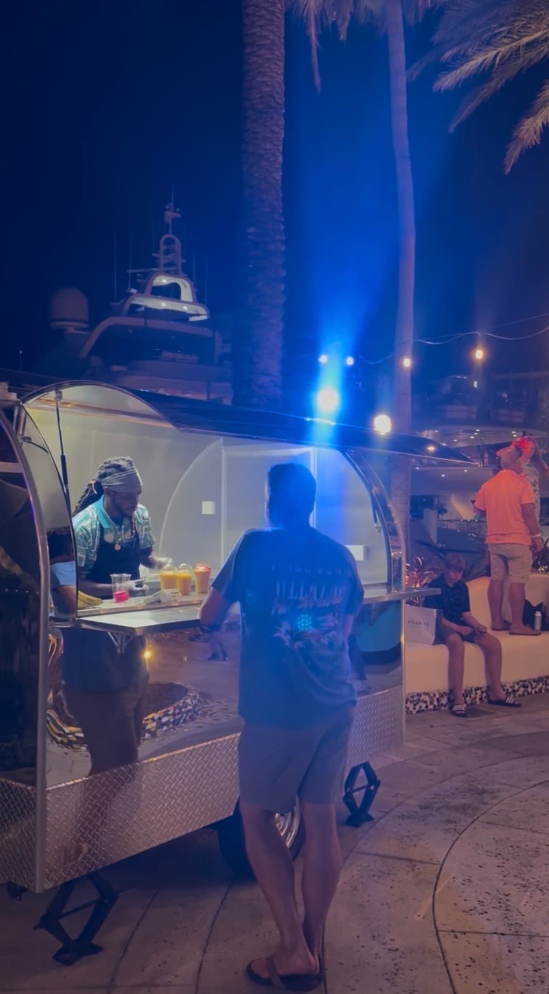 A guest ordering frozen drinks from Lil' Shiny at night