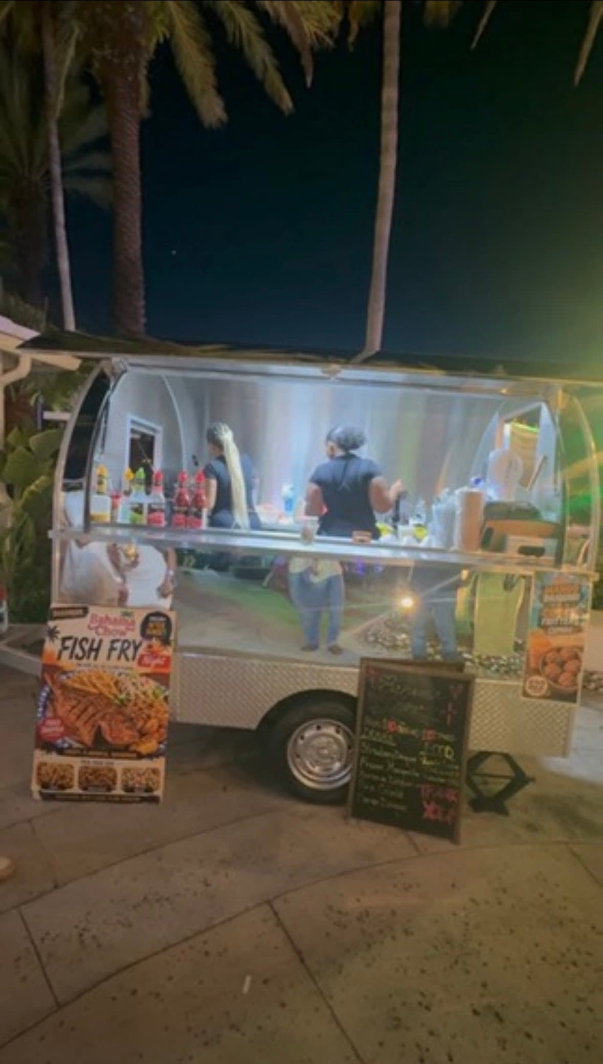 The Bahama Chow crew serving from Lil' Shiny, with the Fish Fry sign out front