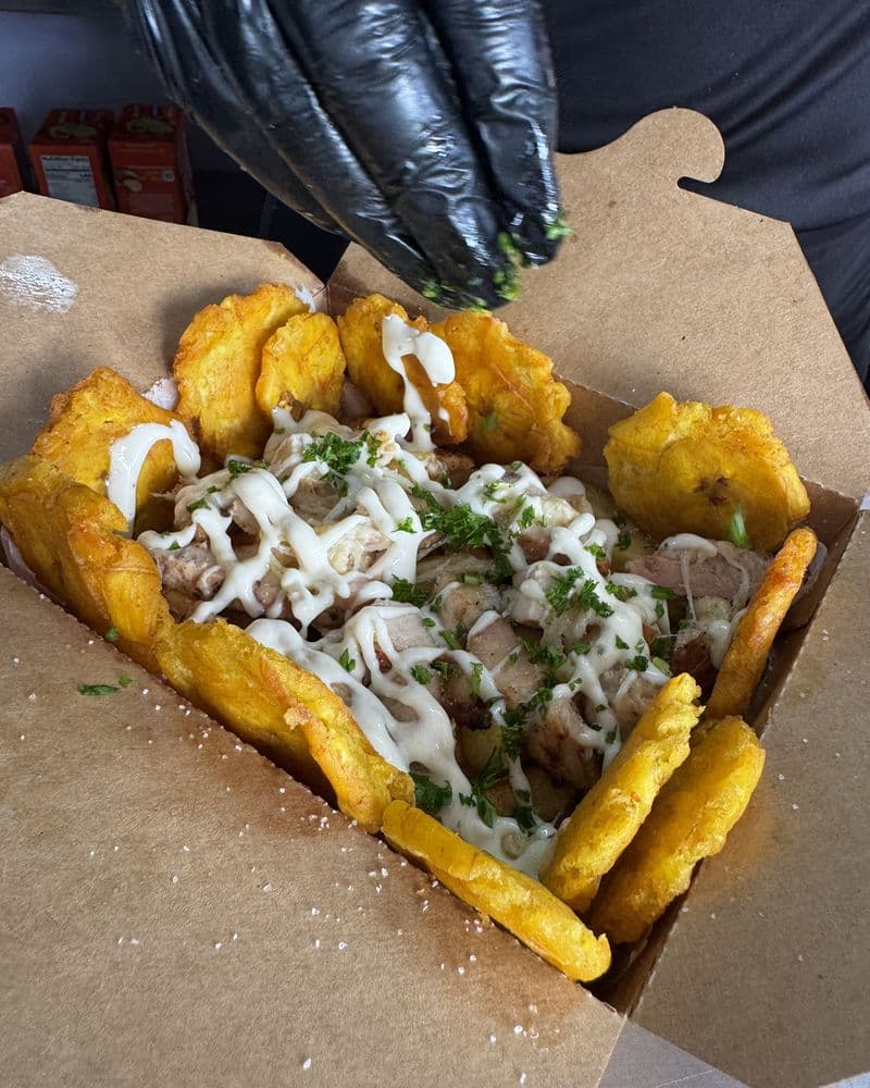 Fried dough, saucy meat and slaw in a takeaway box
