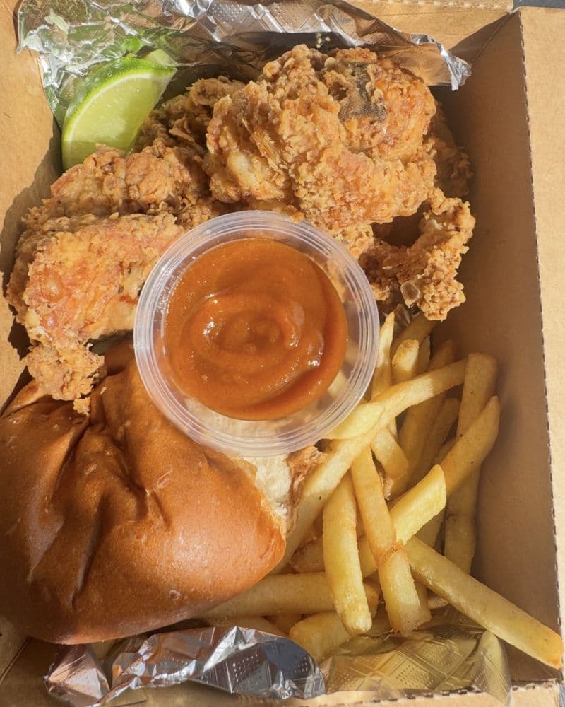 Golden fried seafood with fries and a pot of dipping sauce
